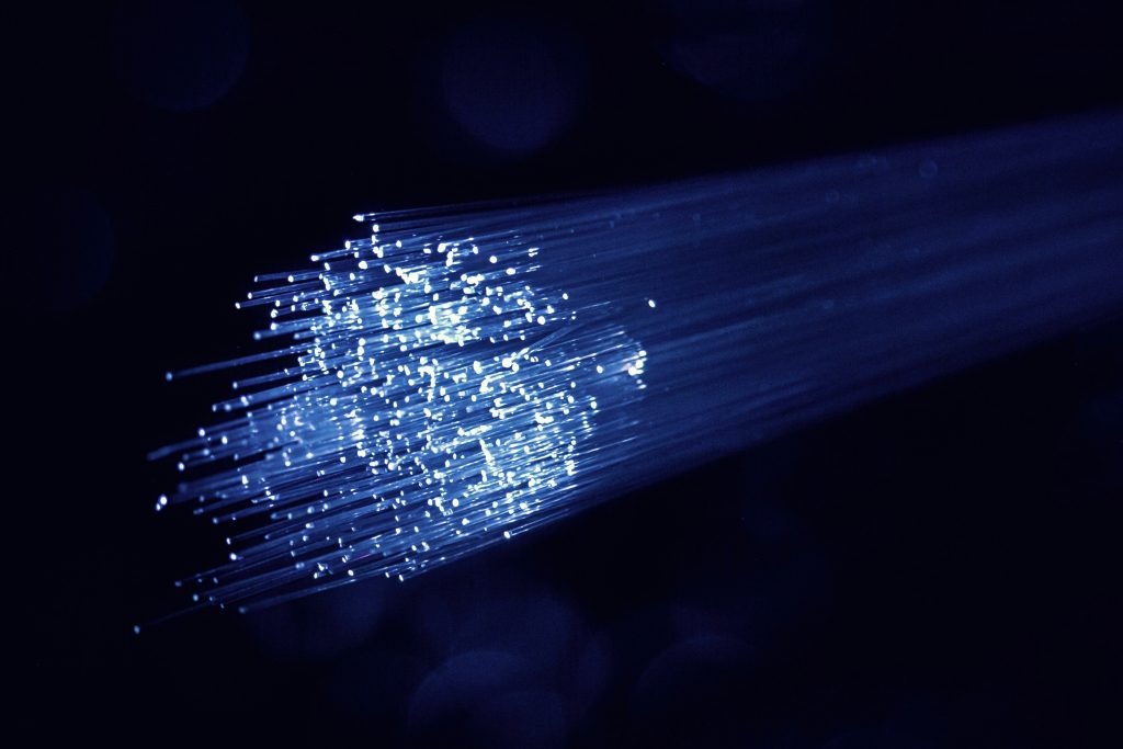 Close-up of a fibre optic bundle with light travelling through the strands